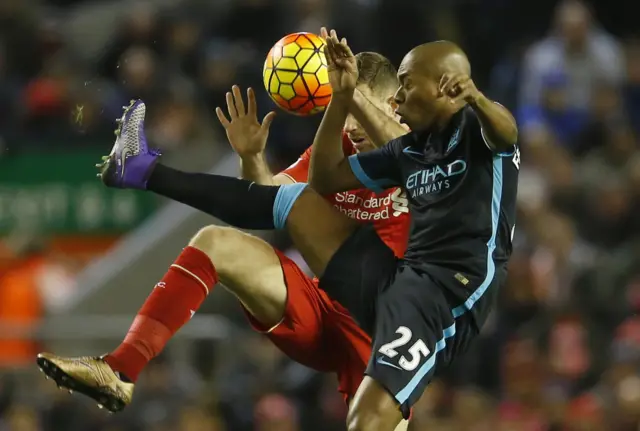 Fernandinho challenges for the ball