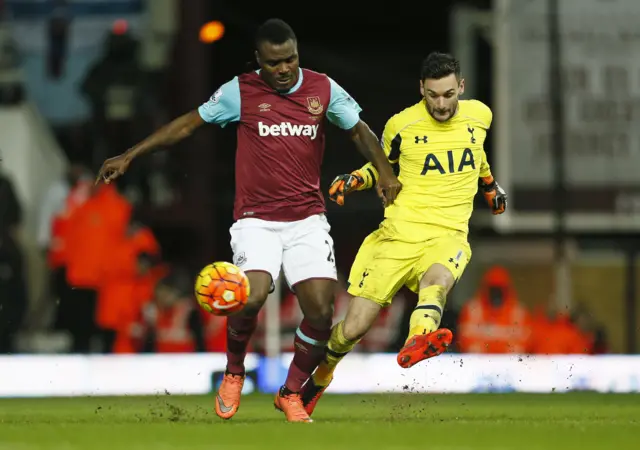 Hugo Lloris in action with West Ham's Emmanuel Emenike