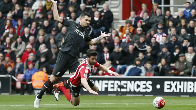 Shane Long goes down under Dejan Lovren's challenge