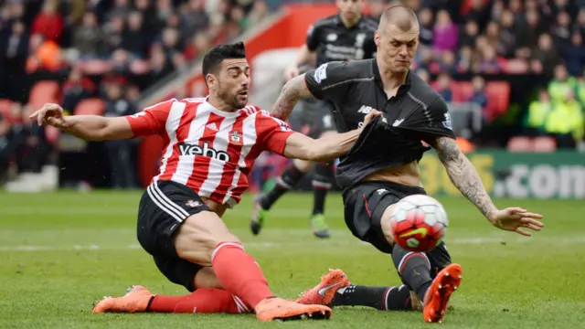 Graziano Pelle wins a penalty after a challenge with Martin Skrtel