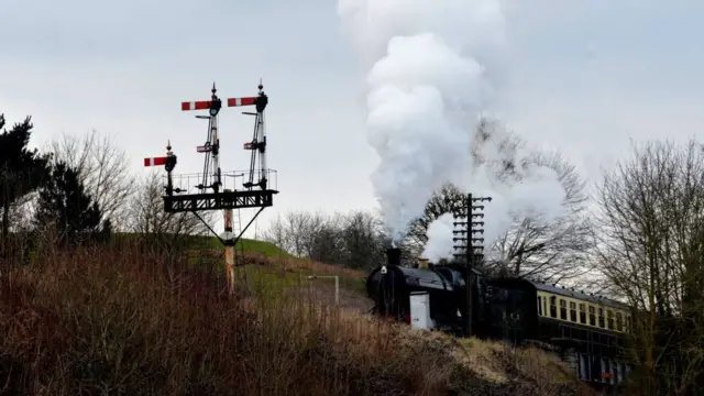 Steam train crossing bridge