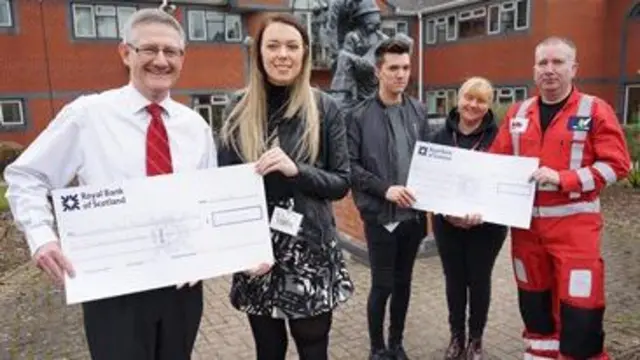 Leah Washington and Joe Pugh presenting cheques