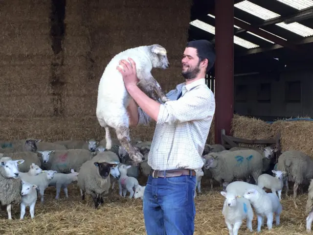 Shepherd holding a lamb