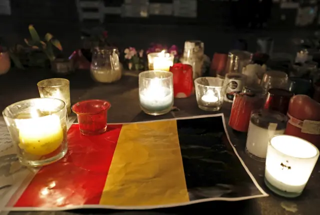 Candles are pictured around a Belgian flag on the Place de la Republique in Paris