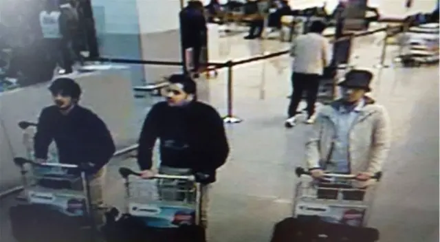 A picture released on March 22, 2016 by the Belgian federal police on demand of the Federal prosecutor shows a screengrab of the airport CCTV camera showing three suspects of this morning's attacks at Brussels Airport, in Zaventem