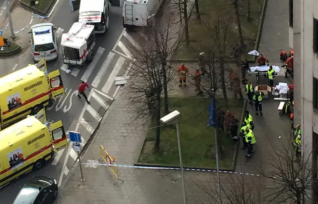 Rescue teams evacuate wounded people outside Maalbeek metro station