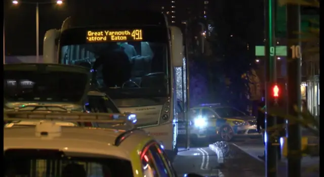 The coach and police vehicles outside Norwich bus station