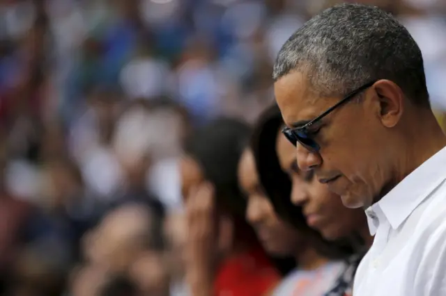 US President Barack Obama observes a minute's silence for the victims of the Brussels attacks prior to a baseball game in Havana