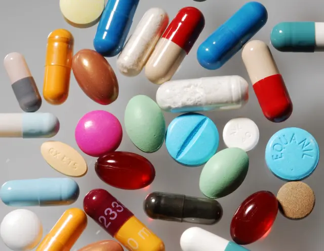 A mixture of pills, in various colours and shapes and sizes