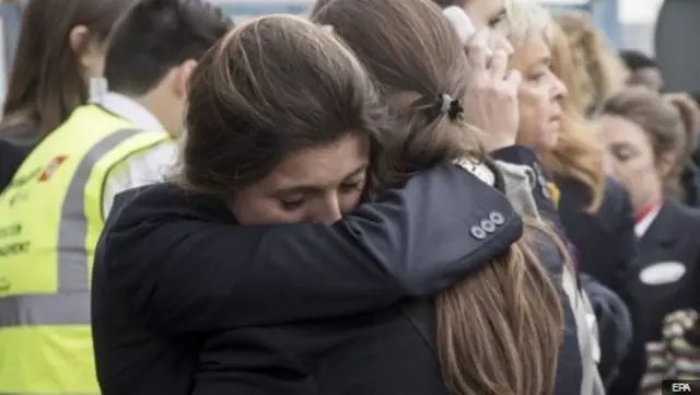 Two women hugging at scene