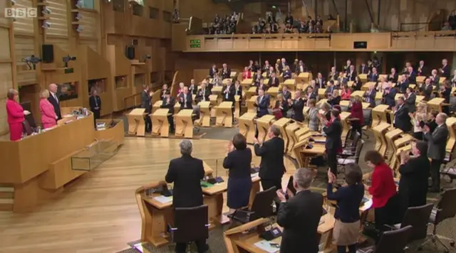 MSPs applaud Presiding Officer Tricia Marwick as she closes her last meeting of Parliament