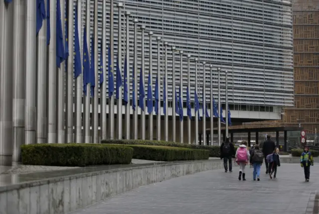 European flags fly at half mast in front of the headquarters of the European Commission in Brussels