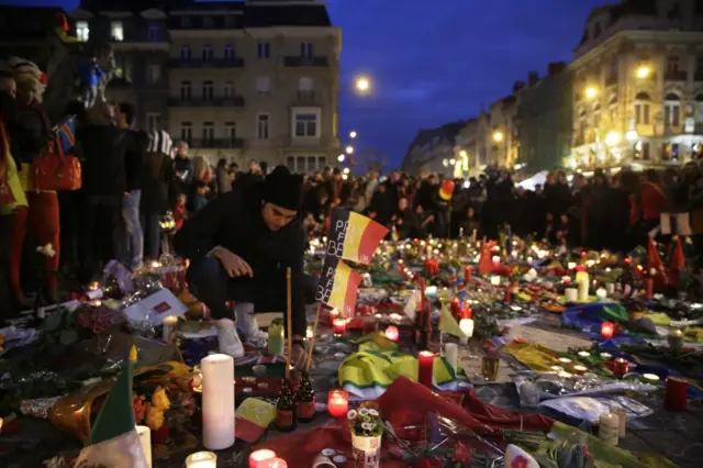 People gather at a makeshift memorial on the Place de la Bourse