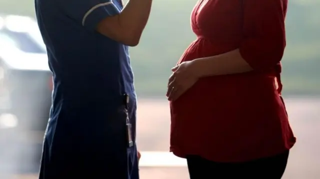 Nurse next to pregnant woman