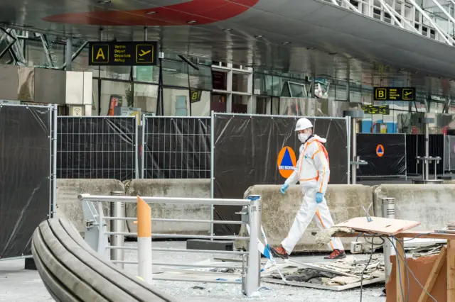 A forensic police prepares outside the terminal at Brussels international airport following bomb attacks in Brussels metro and Belgium"s International airport of Zaventem