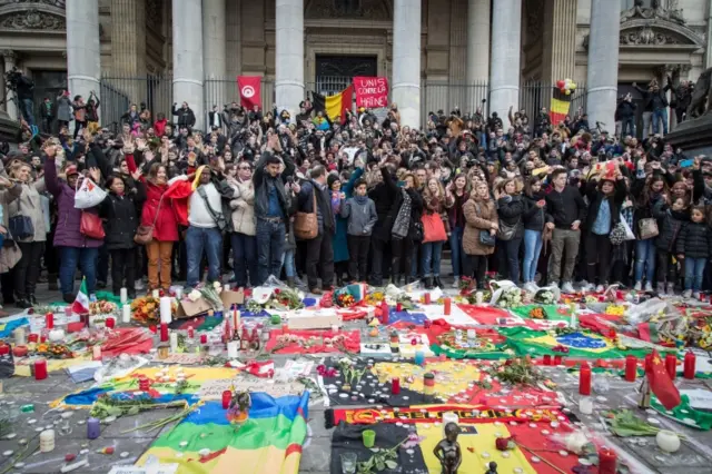 People continue to lay tributes to victims in the Place de la Bourse