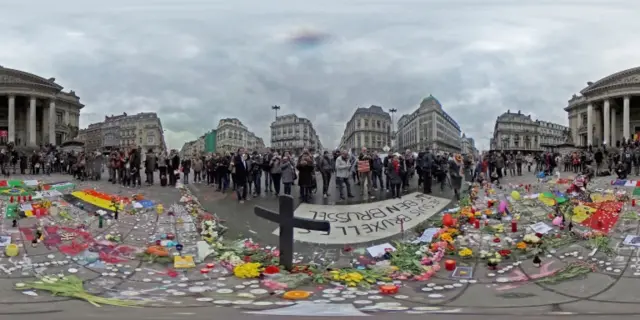 People continue to lay tributes to victims in the Place de la Bourse