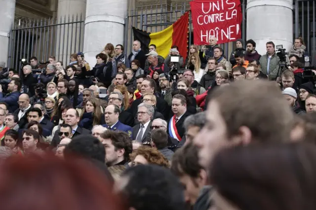 Brussels mayor Yvan Mayeur (centre) joins people for a minute of silence at the city's Place de la Bourse