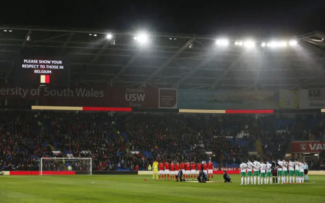 Wales and Northern Ireland players observe a minute silence