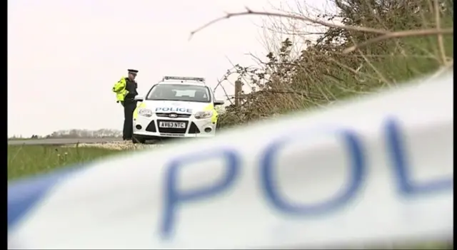 Police tape and police vehicle at Old Buckenham airfield