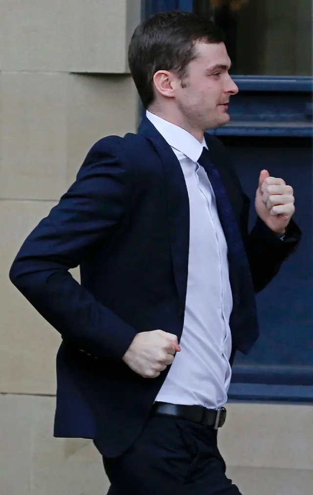 Adam Johnson running into court