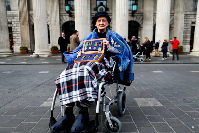 Sheila O'Leary holds a box of her father's medals