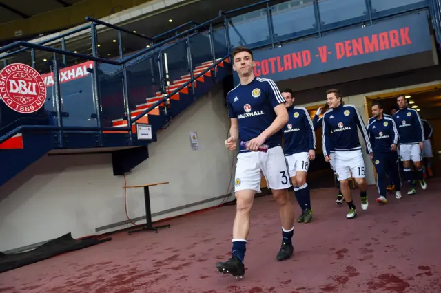 Kieran Tierney leads out the Scotland players for their warm-up