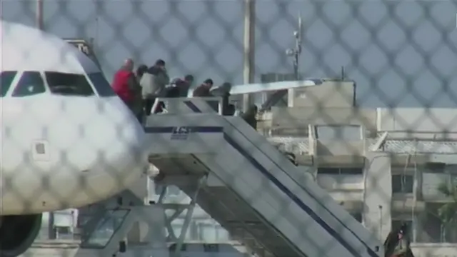 Passengers shown disembarking the plane at Larnaca airport