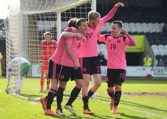 Scotlands Jason Cummings (9) celebrates with teammates after he scores his sides second