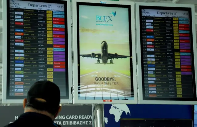 Man looks at departures board