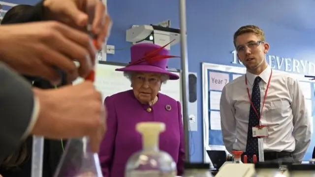 Queen Elizabeth II observes a chemistry lesson during her visit to Lister Community School in London
