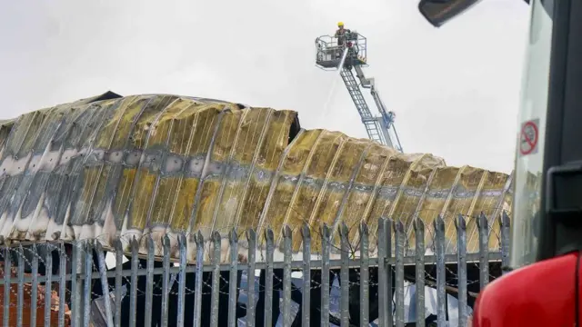Fire fighter pouring more water on to the building