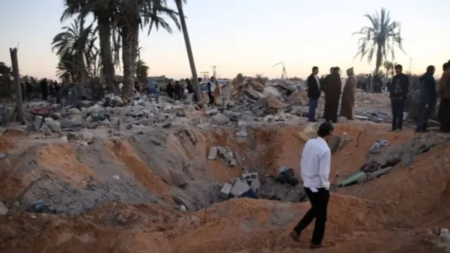 People gather after an air strike in February on a house and training camp belonging to the Islamic State group, west of Sabratha, Libya