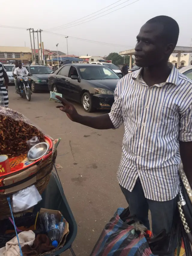 A grasshopper customer in Masaka, Nigeria