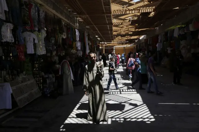 An Egyptian souvenir vendor waits for customers at the Valley of the Kings in Luxor