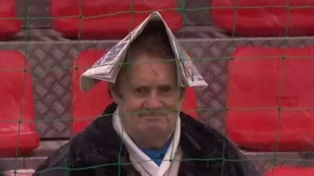 Man in a newspaper hat