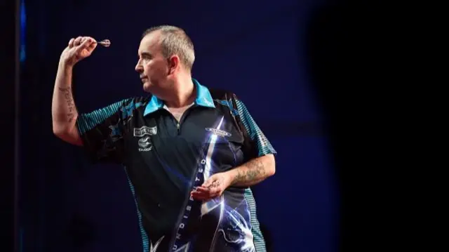 Phil Taylor throwing a dart