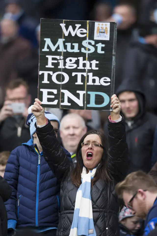 A Manchester City fan with banner