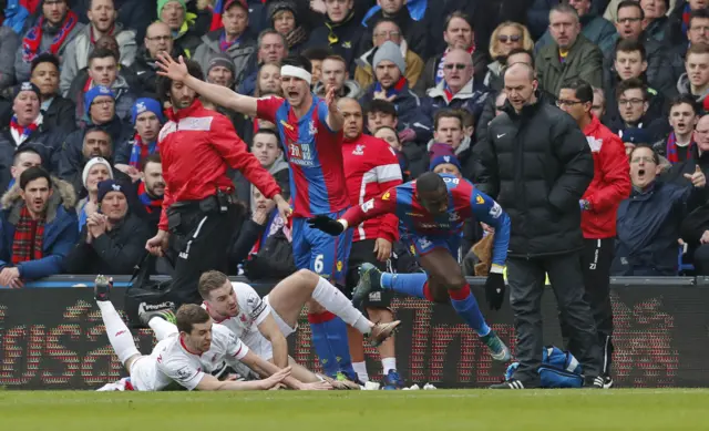 Yannick Boalsie of Crystal Palace tries to escape the attentions of Jon Flanagan and Jordan Henderson