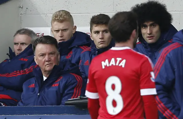 Louis van Gaal watches Juan Mata as he leaves the pitch