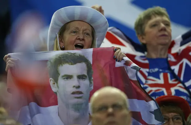 A fan holds a flag