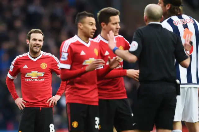 Manchester United players protest the red card decision while Juan Mata looks on