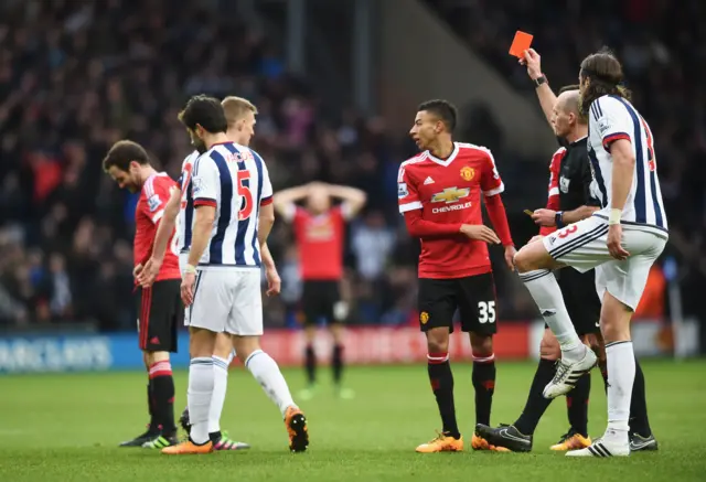 Referee Mike Dean sends off Manchester United's Juan Mata