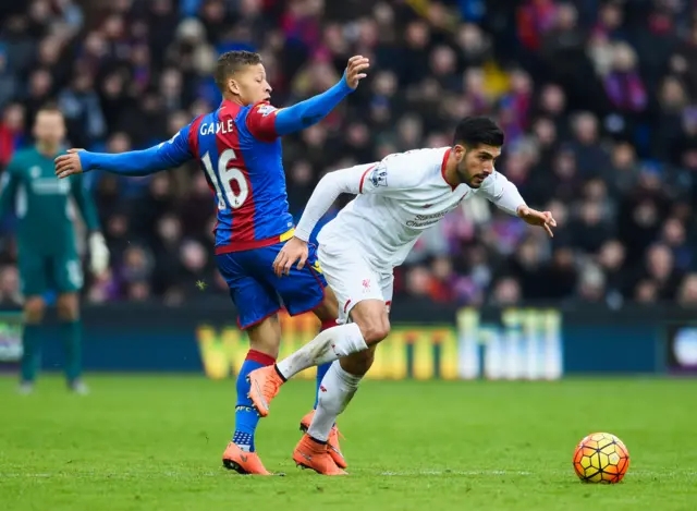 Emre Can of Liverpool escapes the attentions of Dwight Gayle