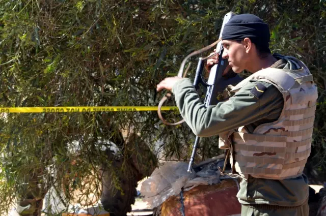 Tunisian soldiers stand guard at the scene of an assault on a house outside the town of Ben Guerdane near the border with Libya on March 3, 2016