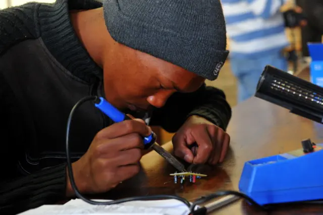 A picture taken on July 7, 2012 shows Edward Bostander, a 16 year old student at Carnavon High School, making a radio, as part of the outreach project by The Square Kilometre Array (SKA) to groom South African future scientists