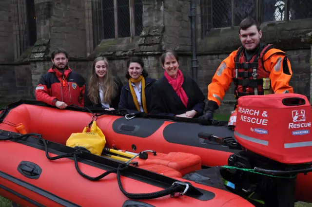 Pupils from Hereford Cathedral School stand with members of the search and rescue team