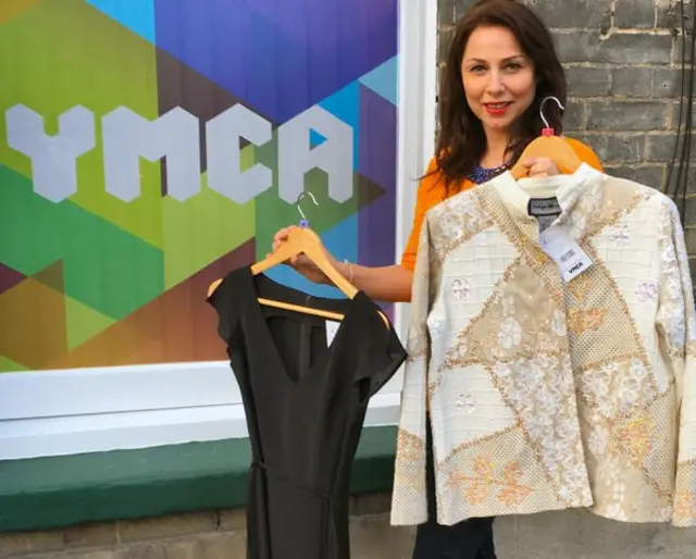 Stephanie Hillier, YMCA Families team manager, with some of the clothes