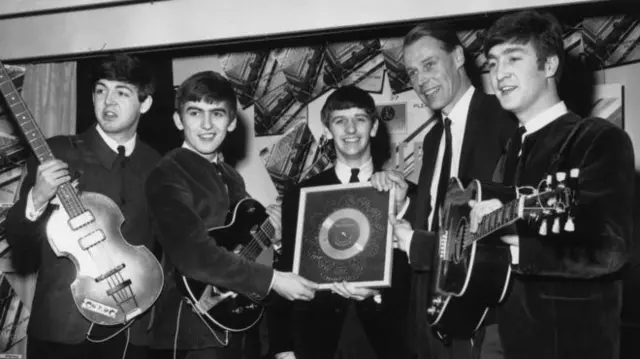 Sir George Martin, pictured with the Beatles in 1963