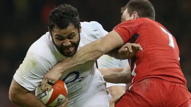 Billy Vunipola is tackled by Sam Warburton